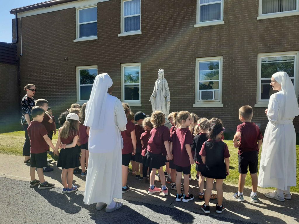 Children Praying along with sisters